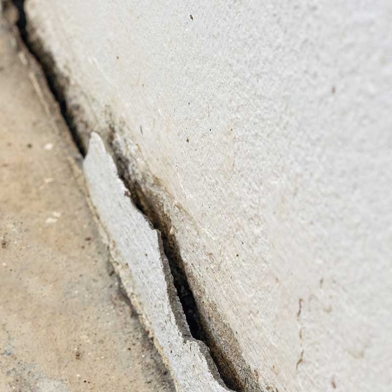 Concrete pad shifted with respect to the adjacent foundation results in a gap between the wall and the concrete pad.